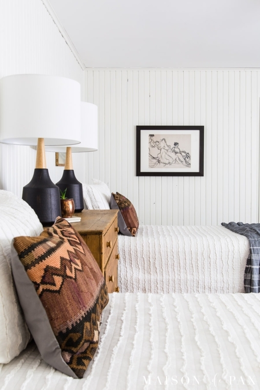White Twin Bedroom featuring Beadboard Walls and Kilim Accent Pillows