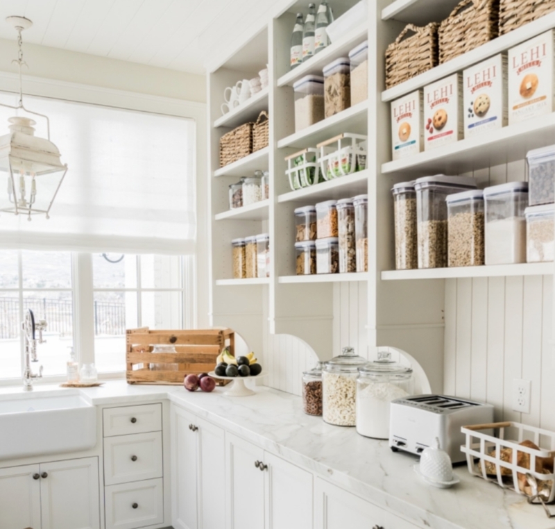 White Walk-In Pantry with Organized Open Shelving and Marble Counters