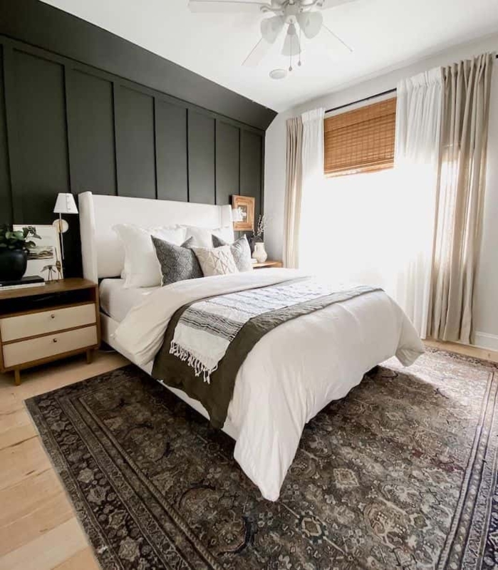 White Wingback Platform Bed against Dark Green Paneled Accent Wall
