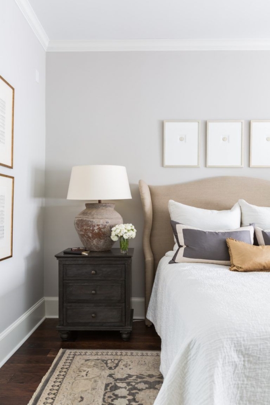 Wingback Bed with Dark Wood Nightstand and Ceramic Lamp Accent