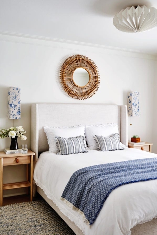 Wingback Headboard with Woven Sunburst Mirror and Floral Sconces