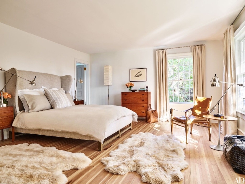 Winged Upholstered Bed with Layered Sheepskin Rugs - Neutral Design