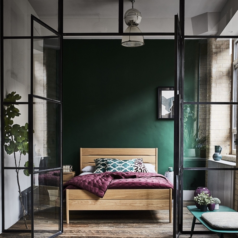 Wood Bed with Slat Headboard behind Industrial Glass Partition