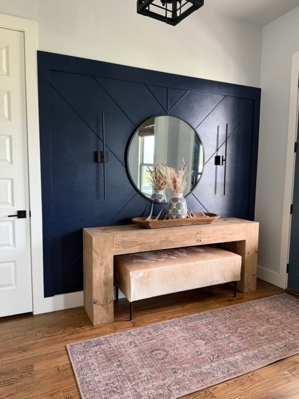 Wood Console Table with Navy Geometric Accent Wall in Entryway