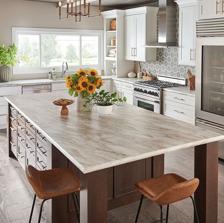 Wood Toned Island and Leather-Like Bar Stools in a Bright Kitchen