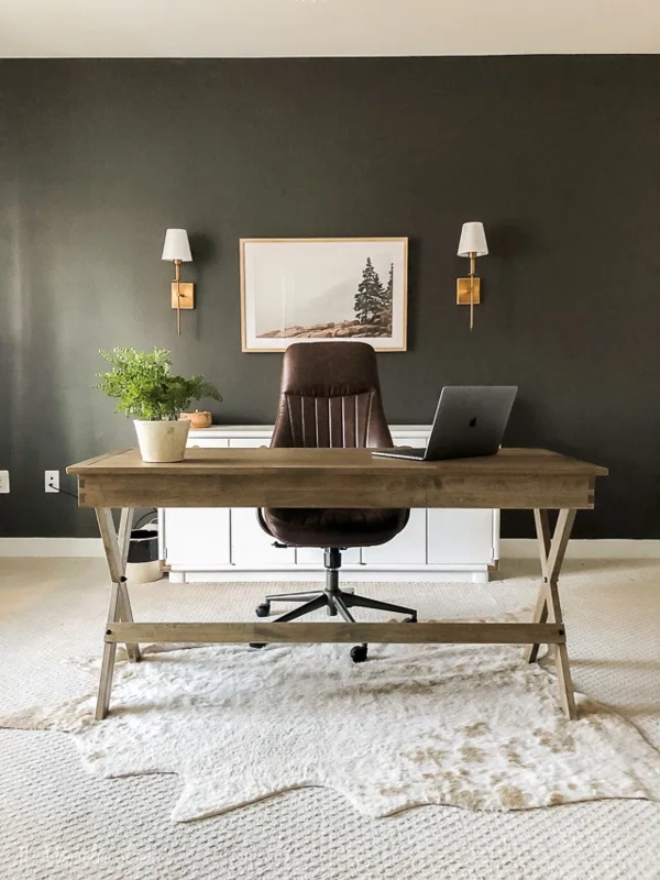 X-Frame Writing Desk Setup with Faux Hide Rug and Dark Accent Wall