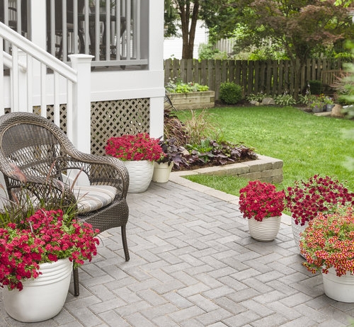 Accent Chair: Herringbone Paver Patio setting with White Fluted Planters