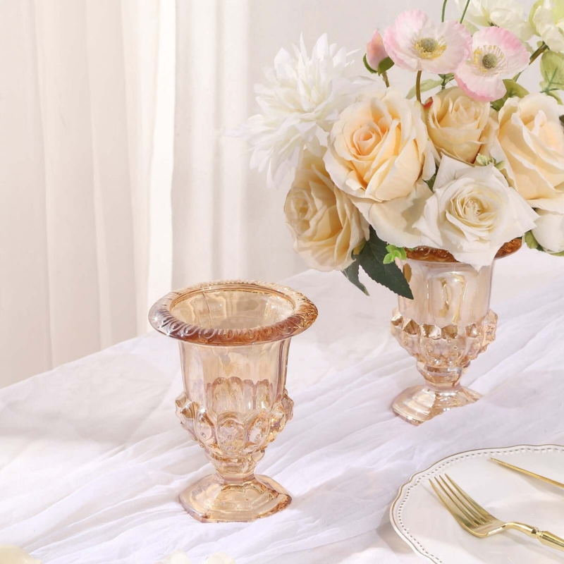 Amber Glass Vase Pair featuring classic roman urn pedestal silhouettes.