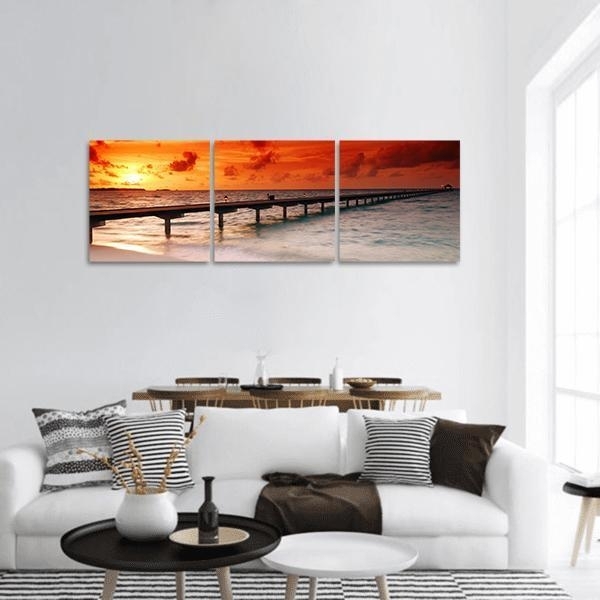 Canvas Wall Art: Triptych Coastal Sunset Pier Imagery with Warm Orange.