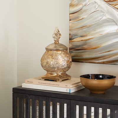 Champagne Gold Decorative Urn with Ornate Scroll Embossing.