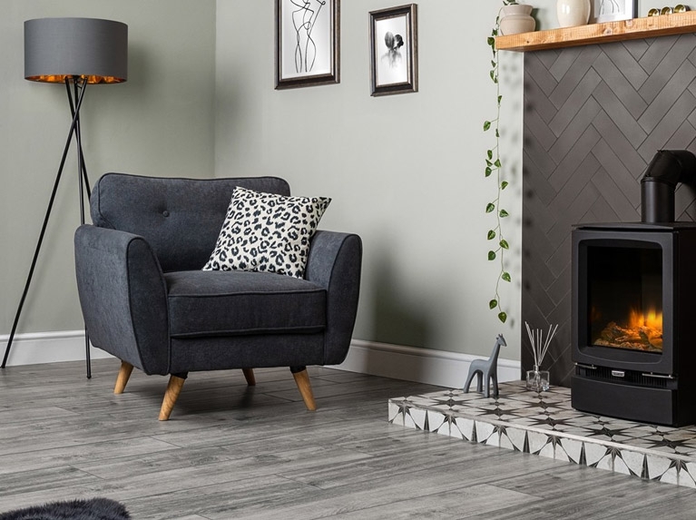 Charcoal Armchair with Tapered Legs and Herringbone Tile Fireplace