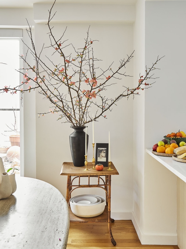 Decorative Vase: Matte Black Ceramic holding Oversized Flowering Branches.