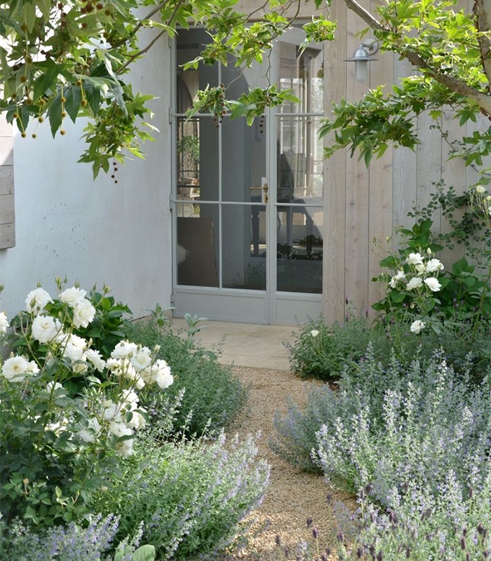 Garden Entryway white rose entrance with french doors and gravel path.