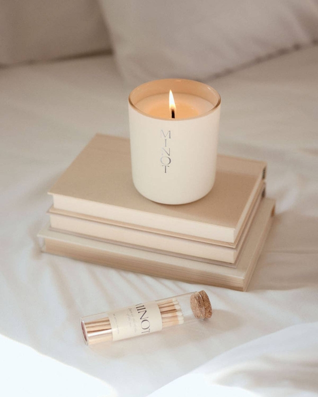 Jar Candle Cream Lit on Book Stack with Glass Match Vial