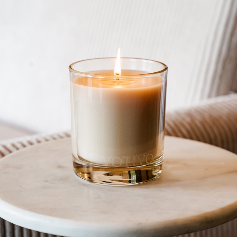 Jar Candle Off-White Wax Lit on Marble Table Etched Branding