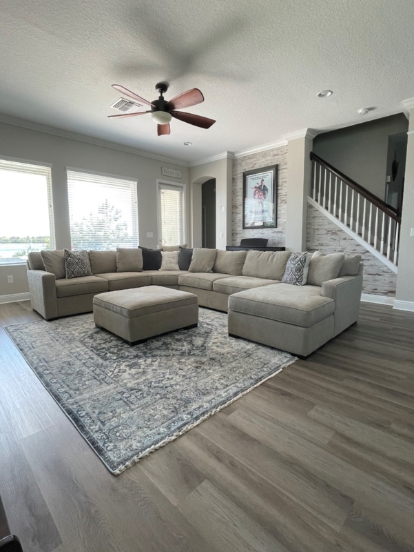 Laminate Wood Accent Wall and Large Sectional Living Room Layout
