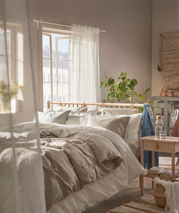 Scandinavian Style Wooden Spindle Bed with Layered Linen Bedding