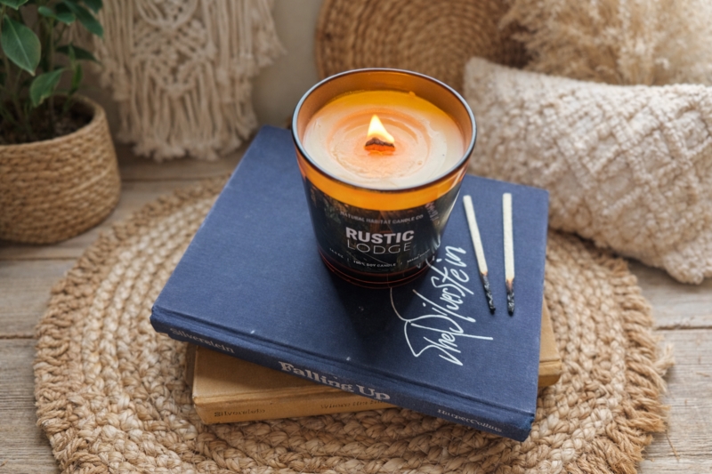 Warm Amber Candle on Navy Books with Wooden Wick and Jute Mat