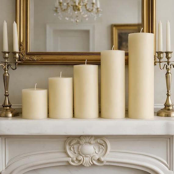 Wide Ivory Pillar Candles Graduated Heights on Marble Mantel