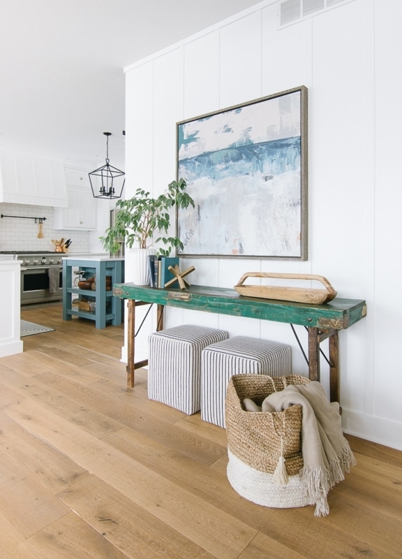 Distressed Green Console Table Styling with Tucked Poufs & Art