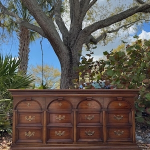 Traditional Triple Dresser with Four Arched Panels and Brass Pulls