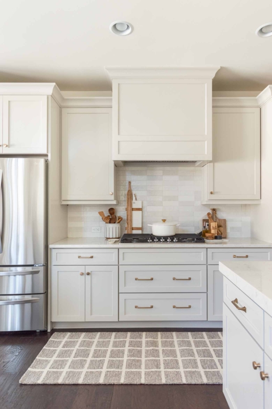 Agreeable Gray Shaker Cabinets with Gridded Rug & Gold Hardware