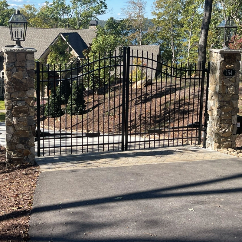Arched Double Driveway Gate with Stone Pillars and Finials