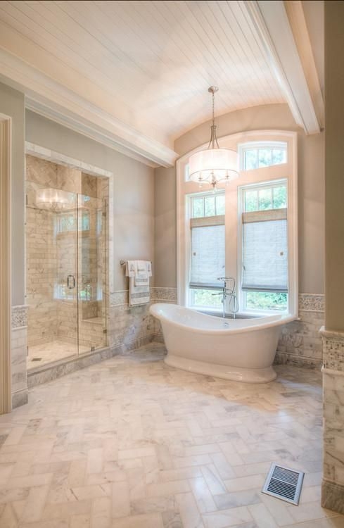 Bathroom Herringbone Marble Floors Freestanding Tub Vaulted Ceiling Arched Window