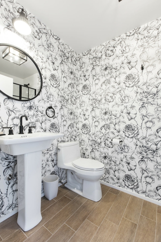 Bathroom Powder Room with Floral Wallpaper and Wood Look Flooring