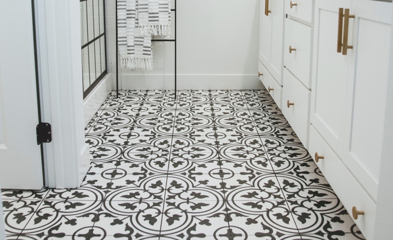 Black and White Bathroom Tile Floor with Gold Cabinetry Hardware