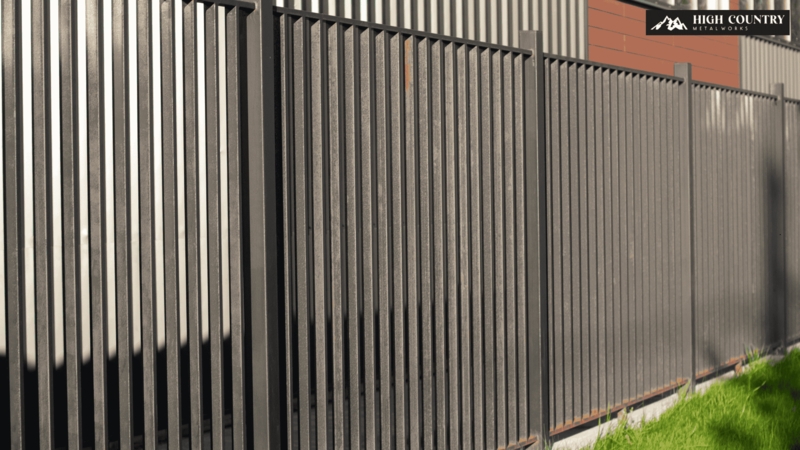 Charcoal Metal Privacy Fence with Vertical Slat Design