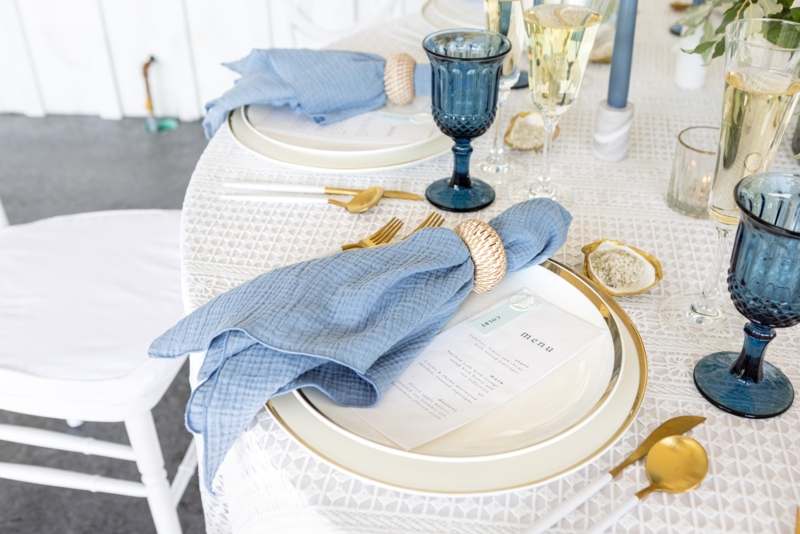 Coastal Table Setting with Linen Napkins and Gold Accents