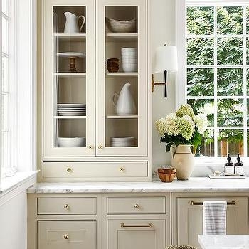 Cream Built-in Cabinetry with Glass Upper Doors and Brass (66 characters)