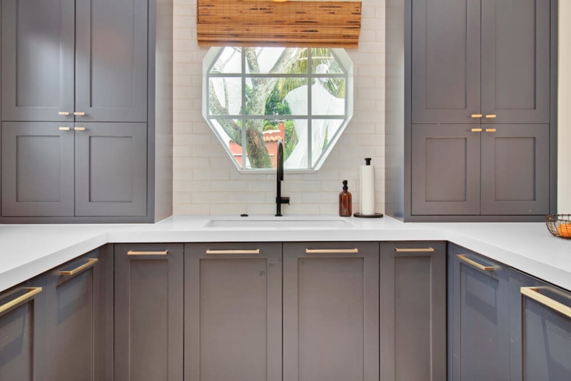 Dark Gray Shaker Kitchen Cabinets with Hexagonal Window & Gold Hardware