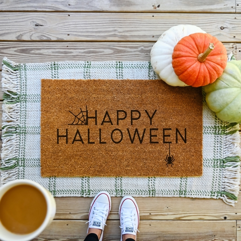 Doormat "Happy Halloween" Spider Web Graphic Layered on Fringed Plaid Rug