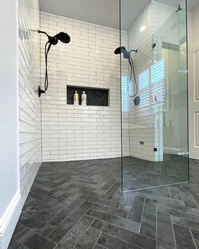 Dual Shower Heads and Herringbone Floor Tile in Walk-In Shower