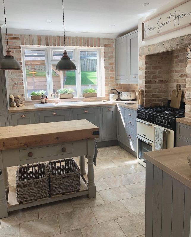 Farmhouse Kitchen with Sage Gray Cabinets and Exposed Brick Walls