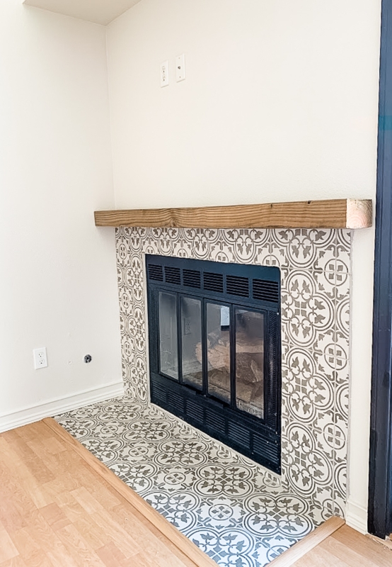 Fireplace: Grey and White Medallion Pattern Ceramic Tile Surround