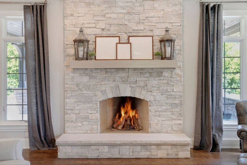 Fireplace: Rustic Stacked Stone Surround with Arched Firebox