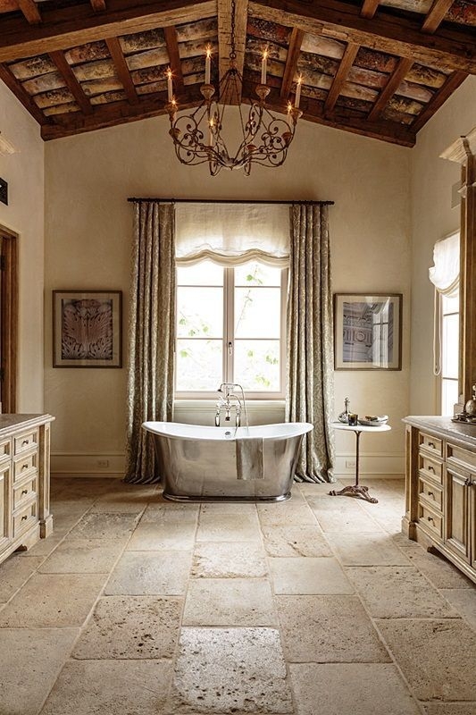 Freestanding Bathtub Metallic Finish Pitted Stone Flooring Beamed Ceiling
