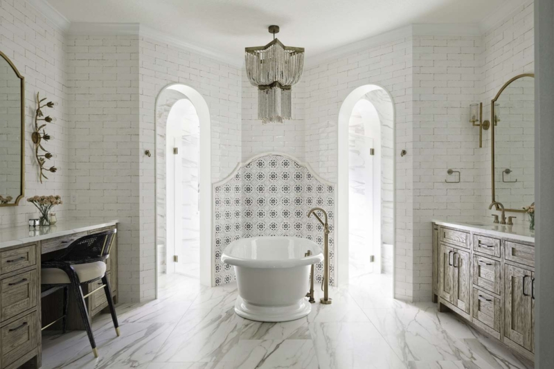 Freestanding Bathtub Symmetrical Arched Openings Tile Backsplash Beaded Chandelier