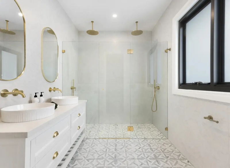 Glam Bathroom Design: Geometric Mosaic Floor Tiles & Gold Hardware