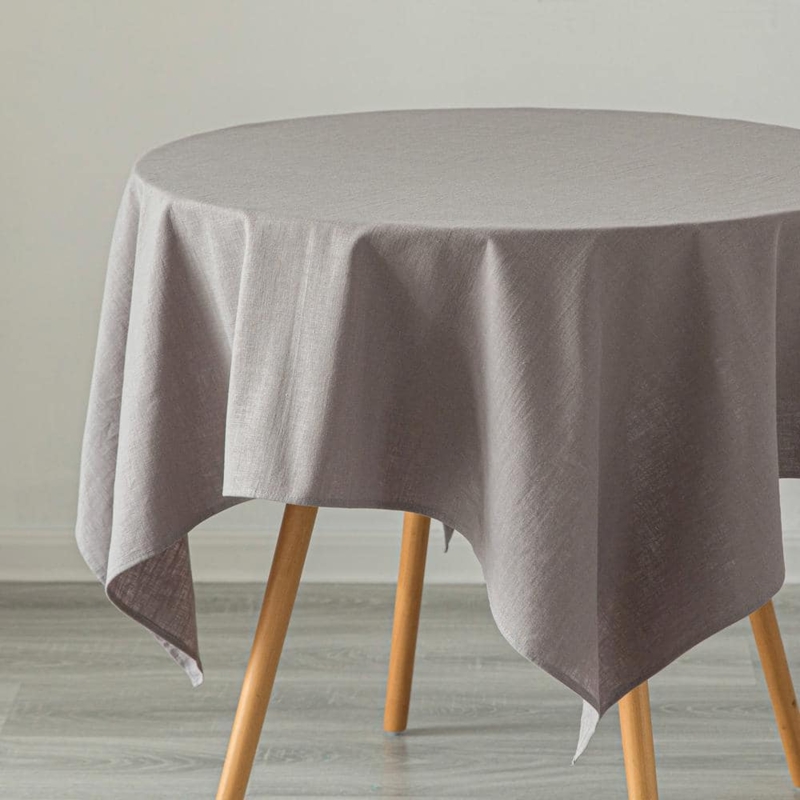 Neutral Gray Rectangular Linen Tablecloth Styled on Round Scandinavian Table.