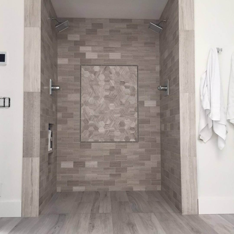 Neutral Stone Look Tile Shower with Hexagonal Accent Wall