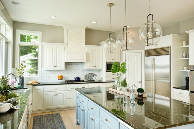 Off-White Shaker Cabinets with Blue Kitchen Island and Globe Pendants