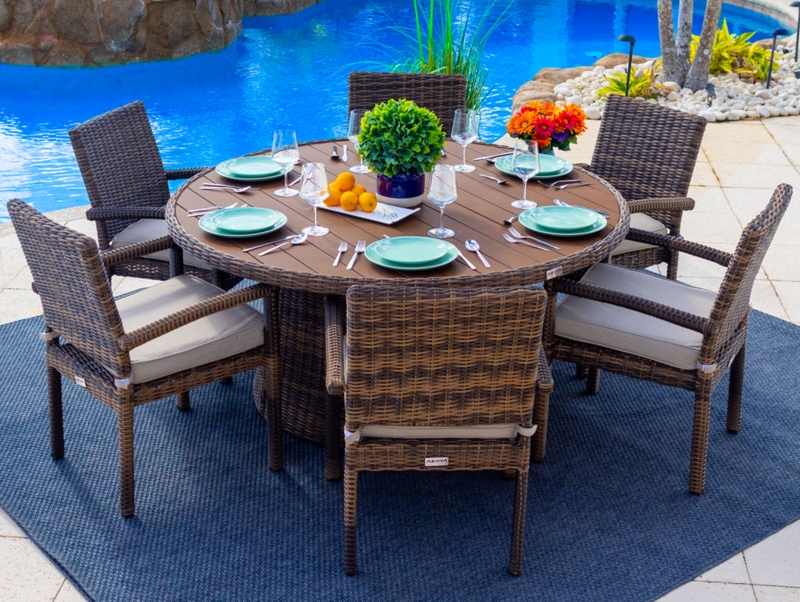 Outdoor Dining Set: Coastal Rattan Look, Woven Pedestal Base, Cushions.