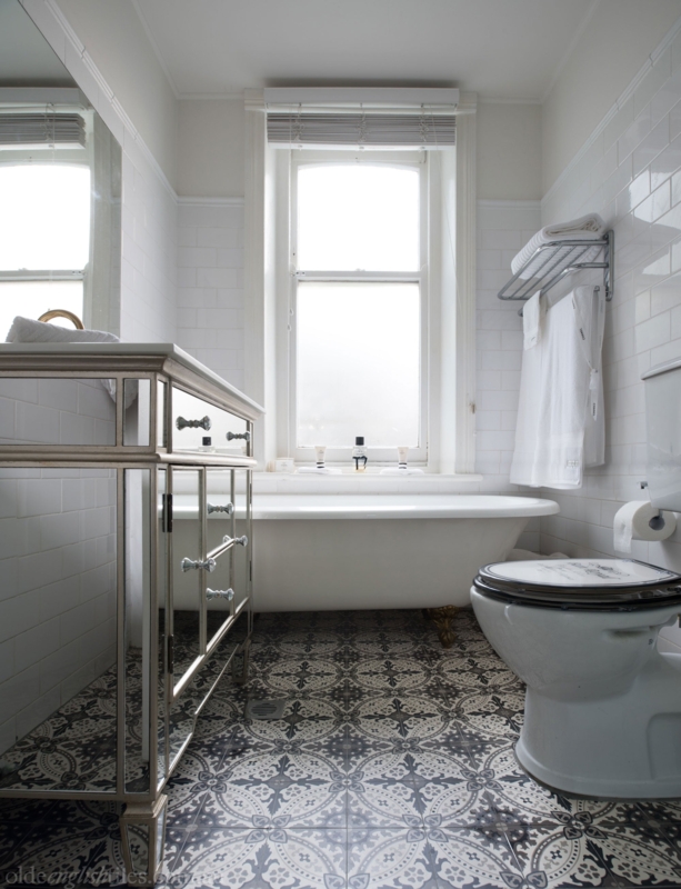 Patterned Encaustic Floor Tile in Vintage Glam Bathroom with Vanity