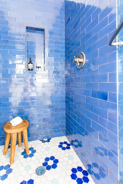 Shower with Cobalt Blue Subway Tile and Hexagonal Flower Floor Pattern