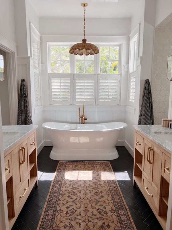 Soaking Tub Layout: Black Herringbone Floor & Light Wood Vanities