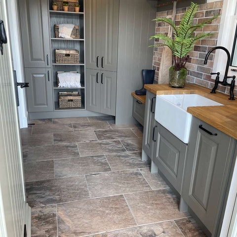 Stone-Look Tiles in Utility Room with Sage Green Cabinets and Brick Wall